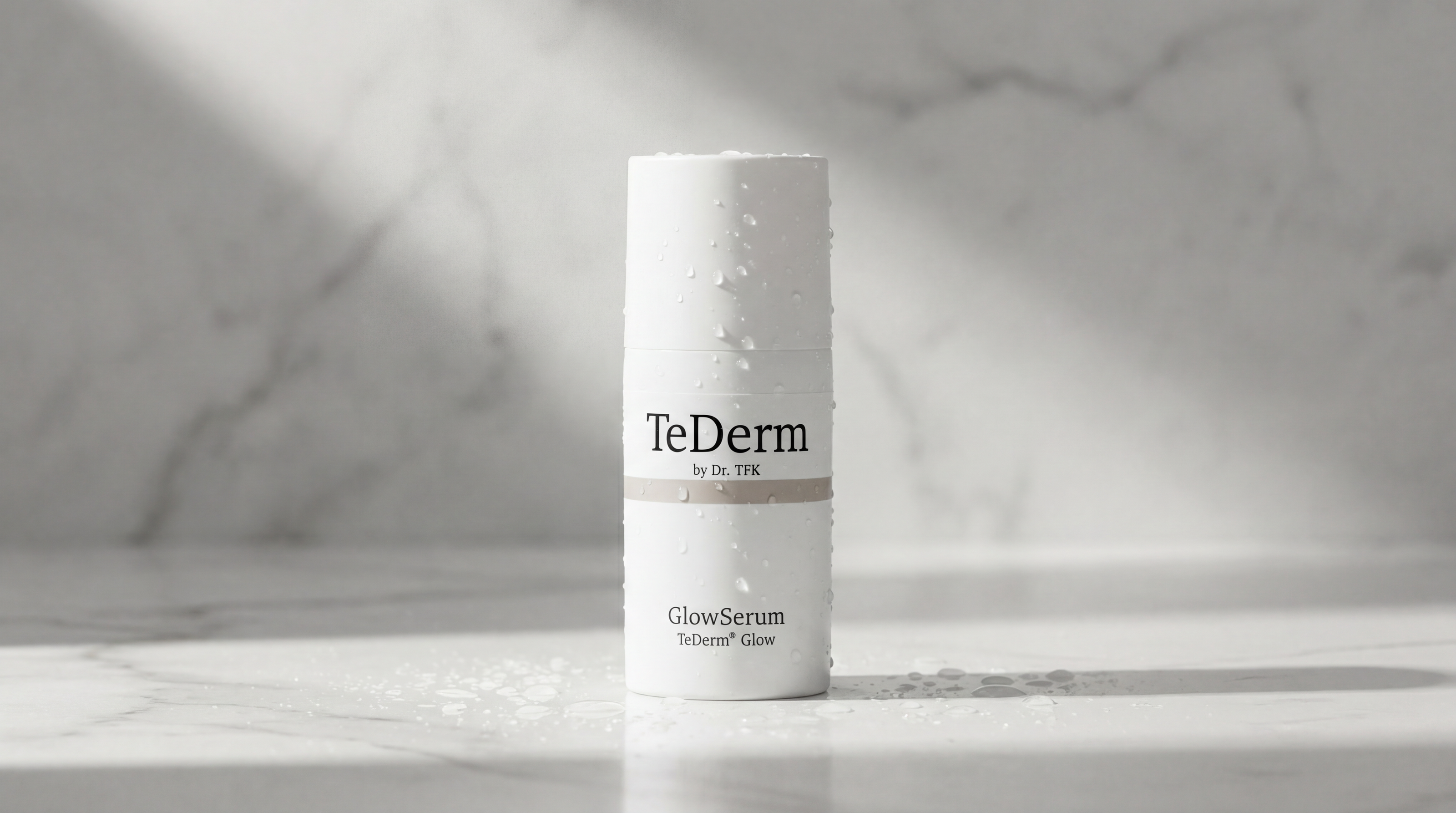 TeDerm GlowSerum bottle with water droplets – widescreen product photo